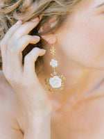 bride wearing gold floral crown or tiara with matching gold floral statement earrings