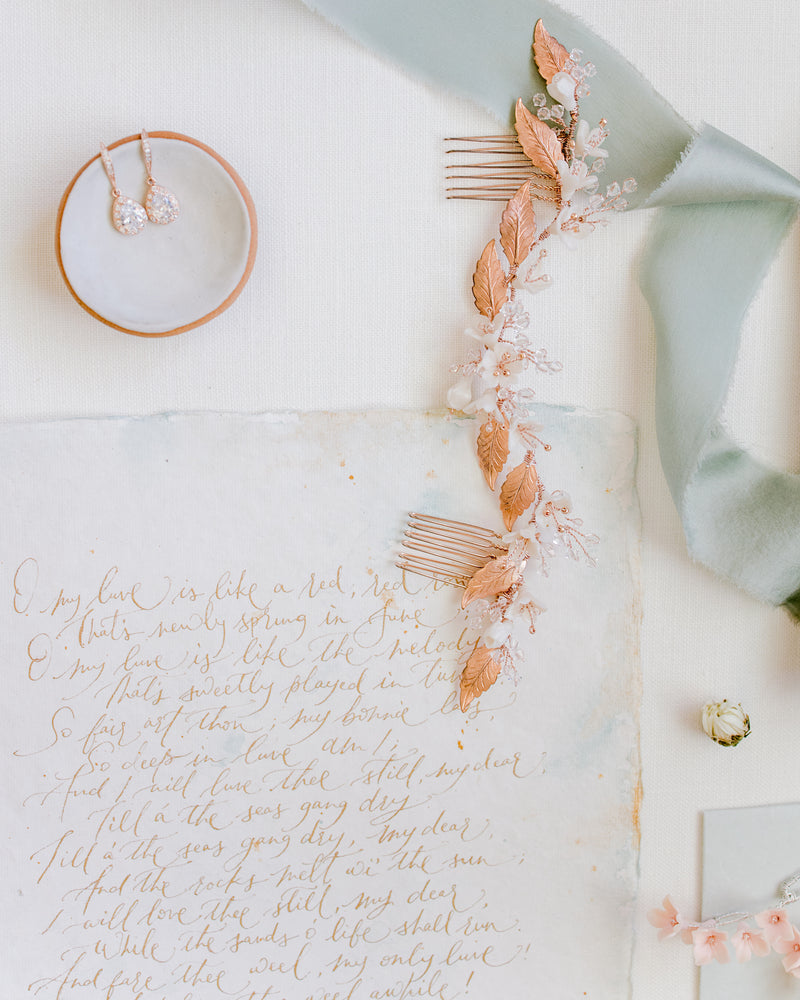 
            
                Load image into Gallery viewer, Flatlay with wedding details with stationery and rose gold hair piece and jewellery
            
        