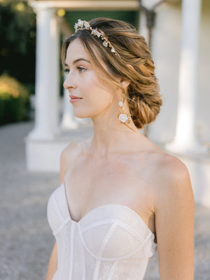 bride wearing a floral wedding crown with blush pearls with floral gold drop earrings
