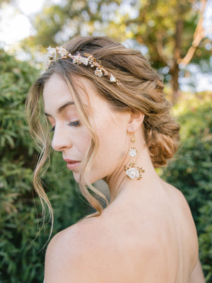 bride wearing a floral wedding crown with blush pearls with floral gold drop earrings