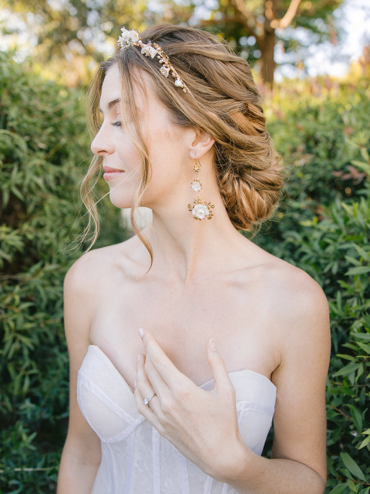 bride wearing a romantic gold blush floral with matching statement bridal earrings 