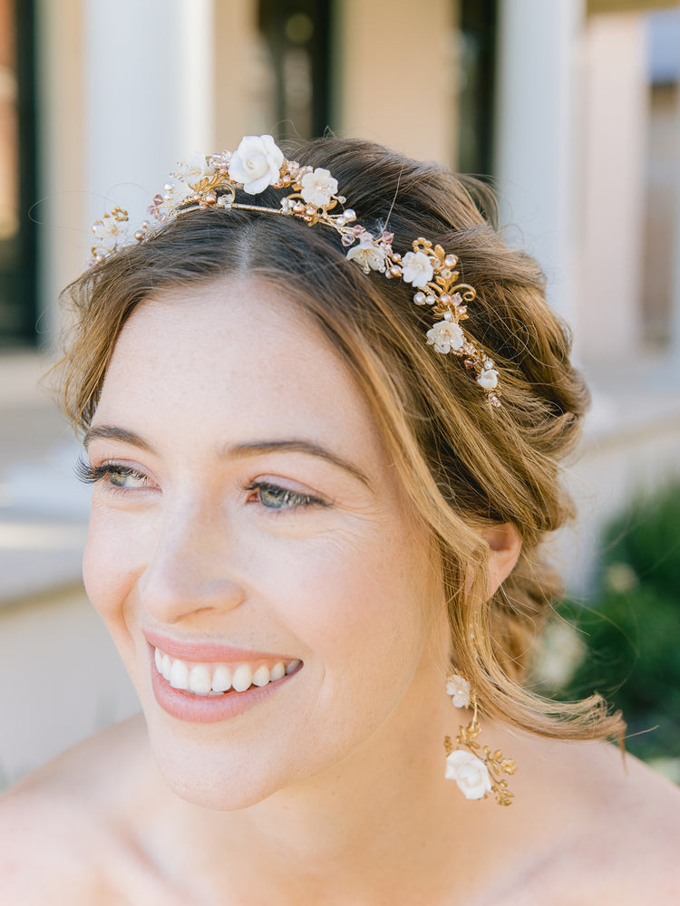bride wearing a floral gold blush wedding crown with blush pearls with floral gold drop earrings
