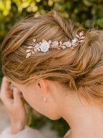 Romantic and modern  bridal updo hairstyle with rose gold hair piece