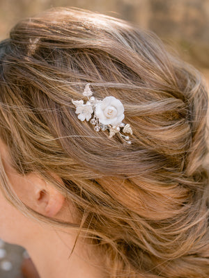 petite and dainty bridal hair comb with floral details and blue crystals