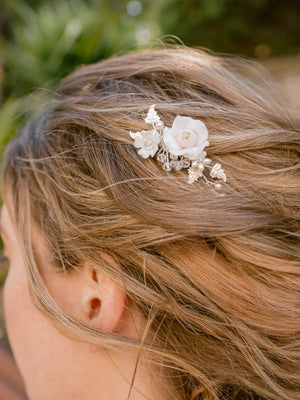 
            
                Load image into Gallery viewer, silver wedding hair piece for bride featuring clay flowers, pearls and crystals that can be worn on the side
            
        