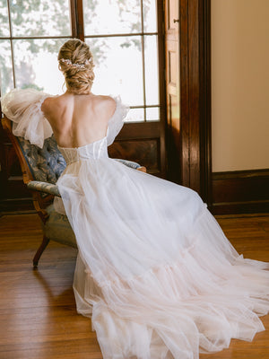 
            
                Load image into Gallery viewer, Rose gold bridal hair piece for updo or hair down on bride with tulle wedding gown sitting in a vintage armchair
            
        